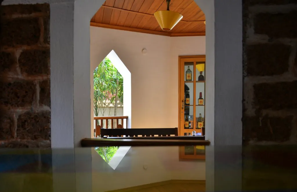 The bar seen through a laterite-stone arch at Cavala