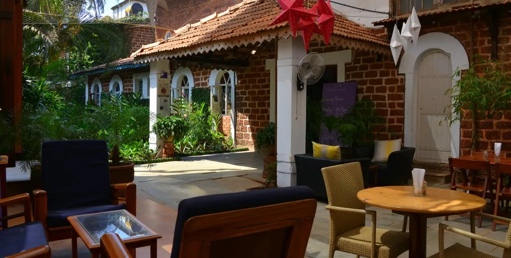 Cavala's Goan courtyard with laterite arches and star lanterns in Baga, Goa