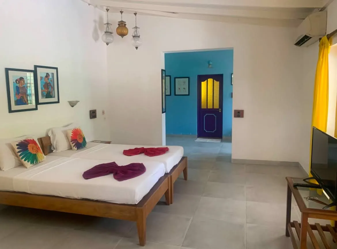 Spacious room with local artwork at Cavala, Baga
