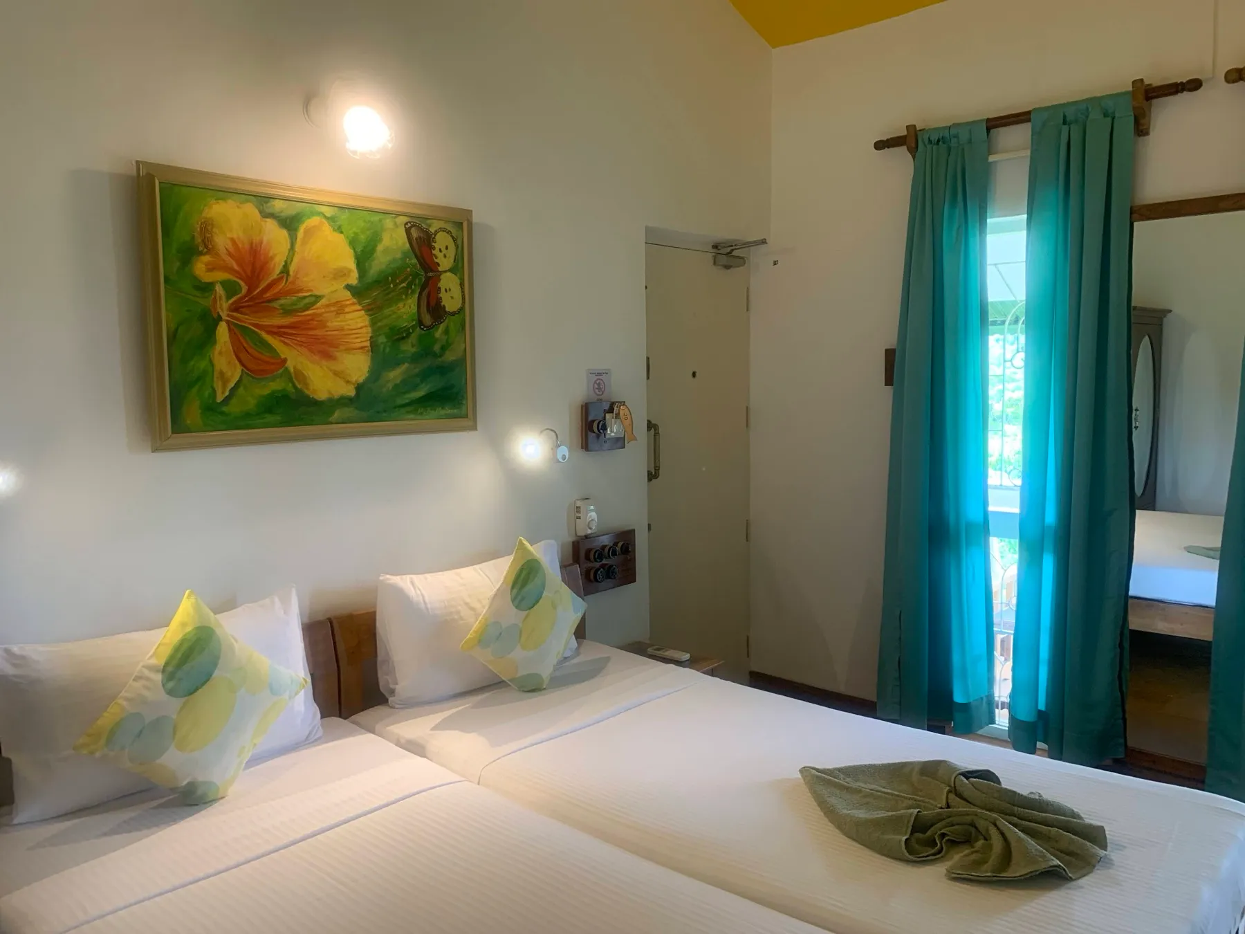 Deluxe Room with double bed and teal drapes at Cavala