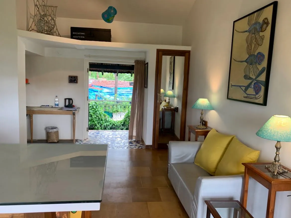 Garden Suite sitting area with sofa and garden view at Cavala